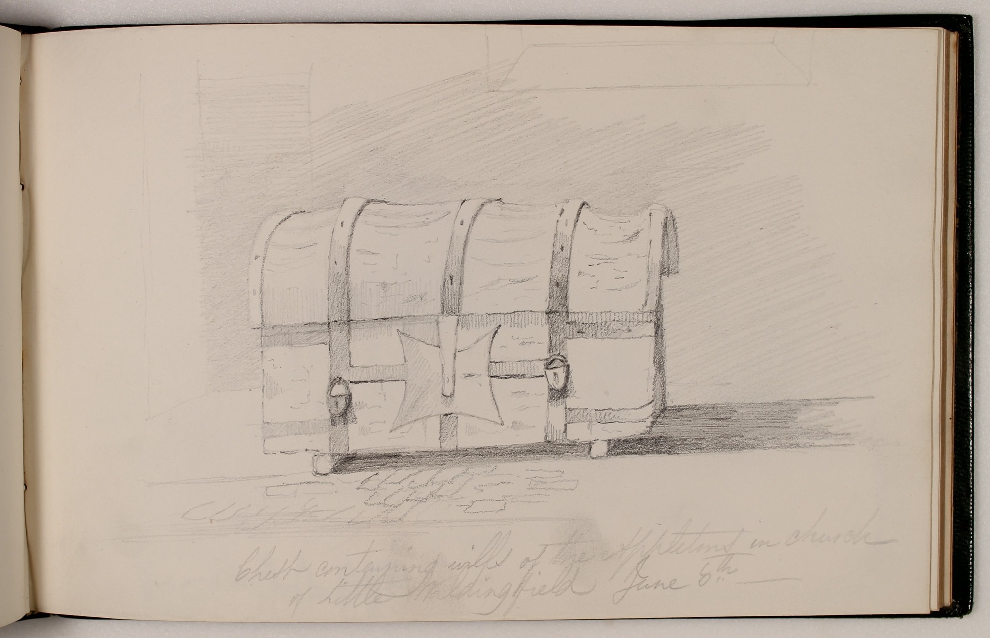 Pencil drawing in sketchbook of wooden chest with rounded top.