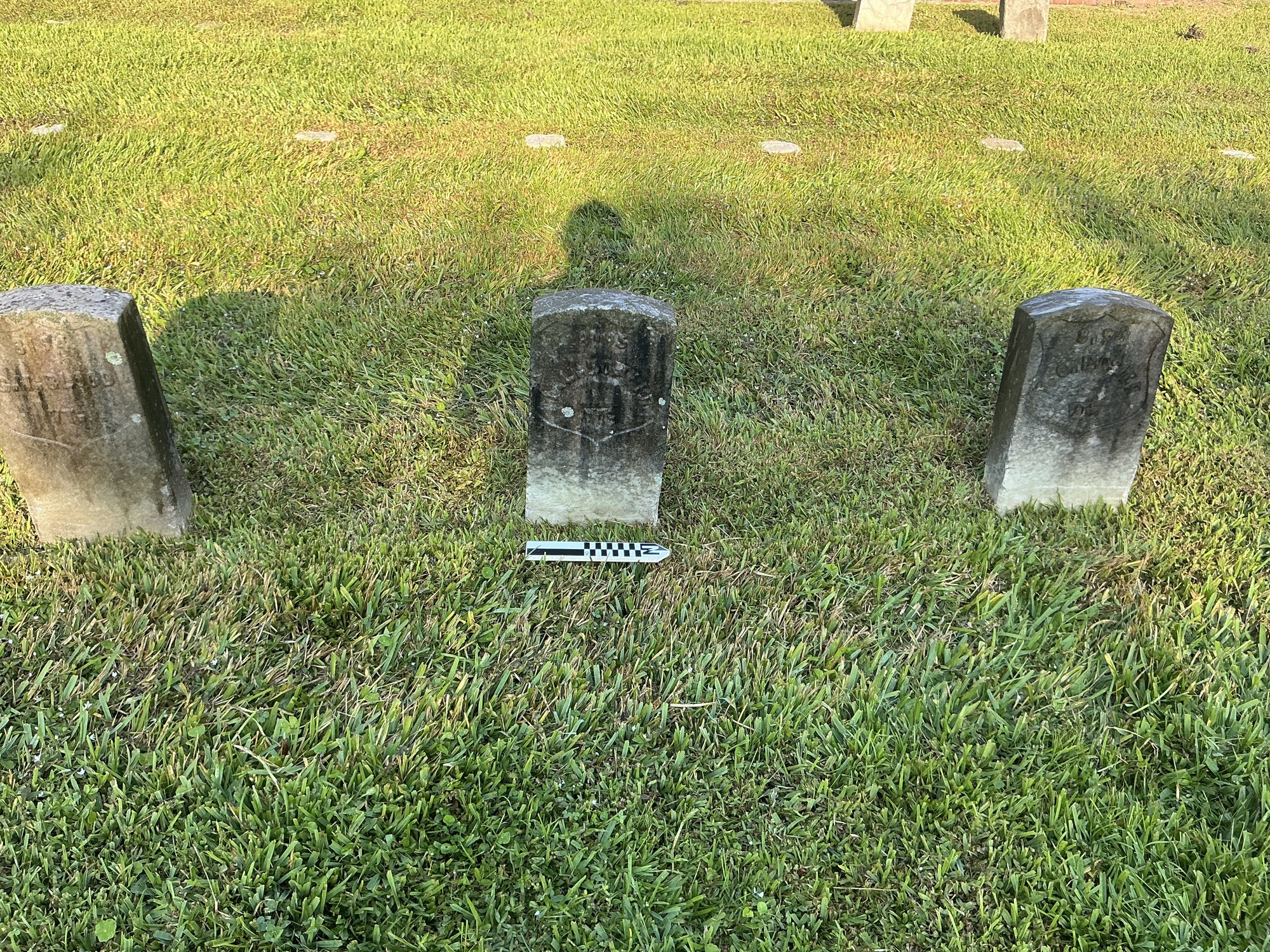 Extra image of historic upright marble headstone with recessed shield face.