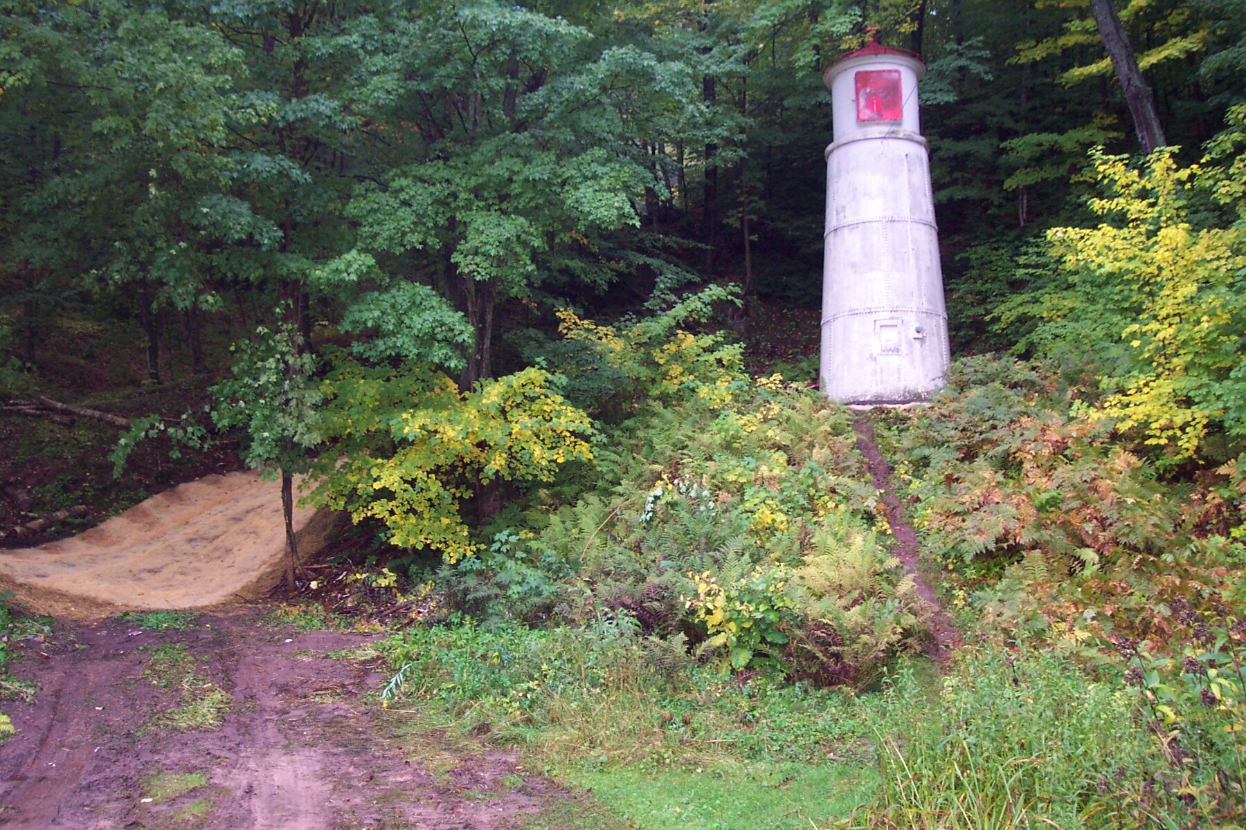 Small lighthouse set into the hillside.