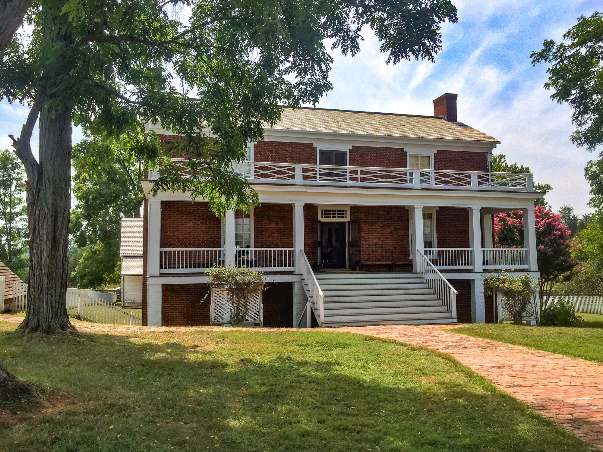 Two-story brick house with a prominent two-story porch