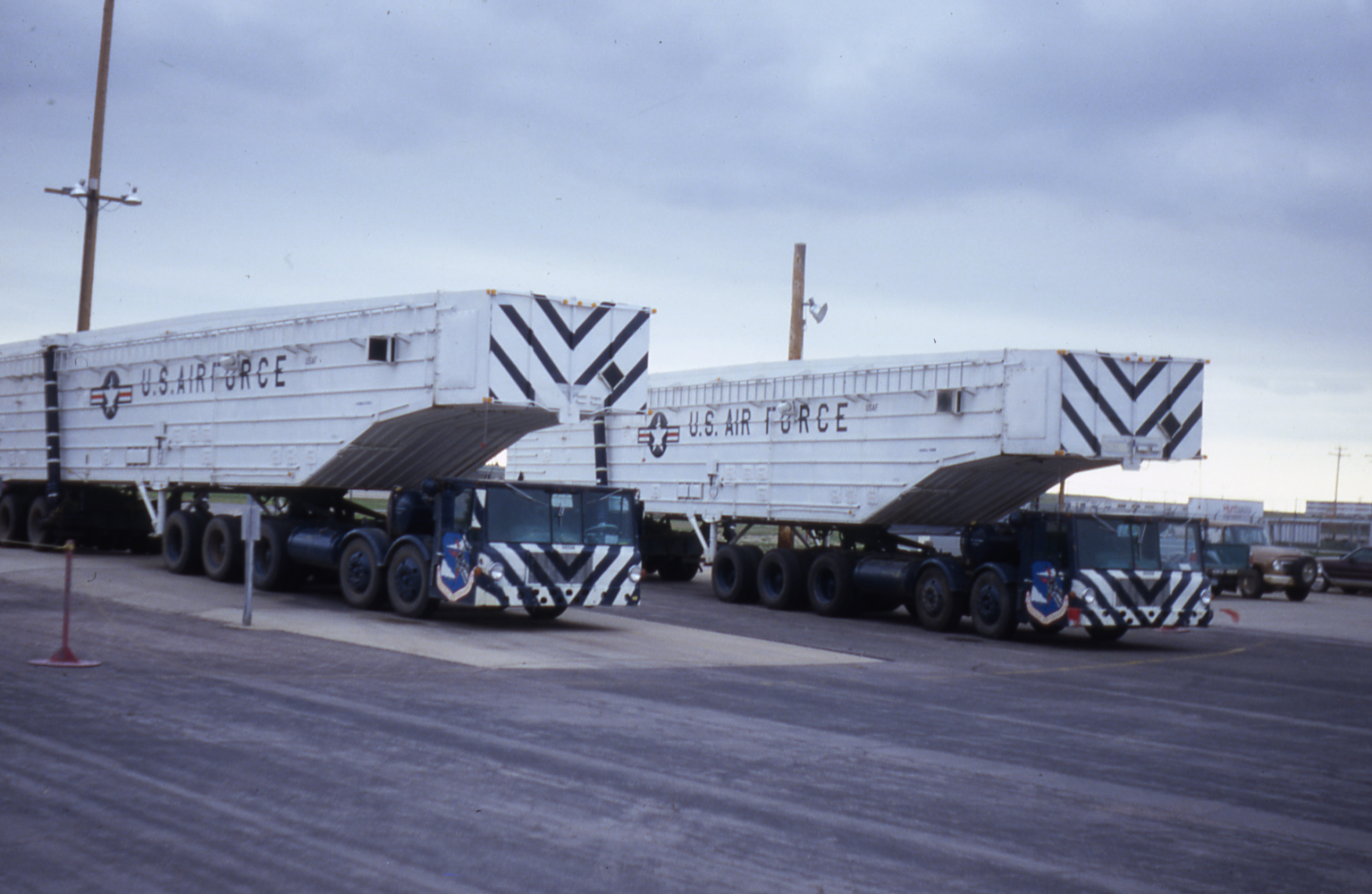 Two transporter erector vehicles stand at the ready