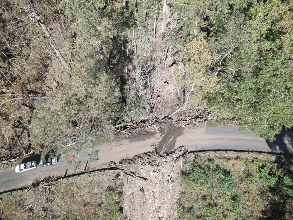 An NPS drone crew surveys damage from a landslide above the Parkway at milepost 374 that washed away trees, the guardrail, and left debris on the motor road. 