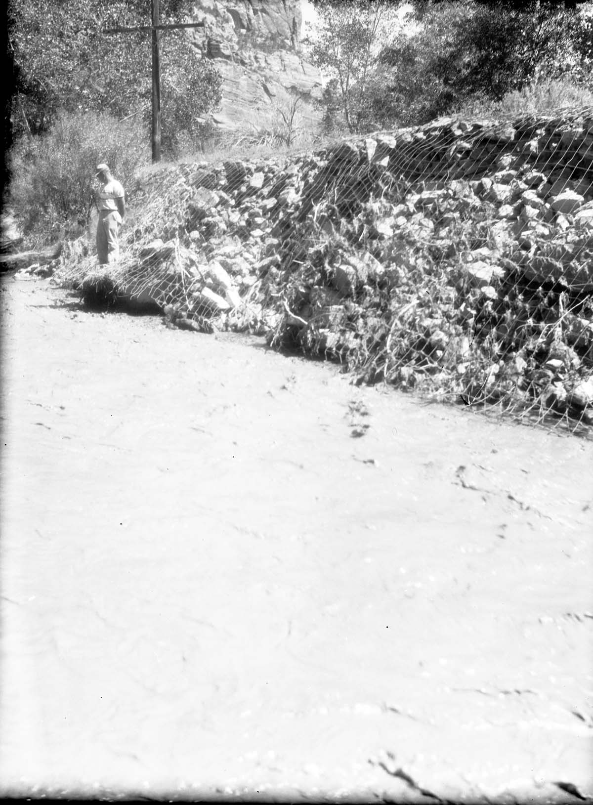Crumbling rock-wire revetment #9 mesh wire rusted through.