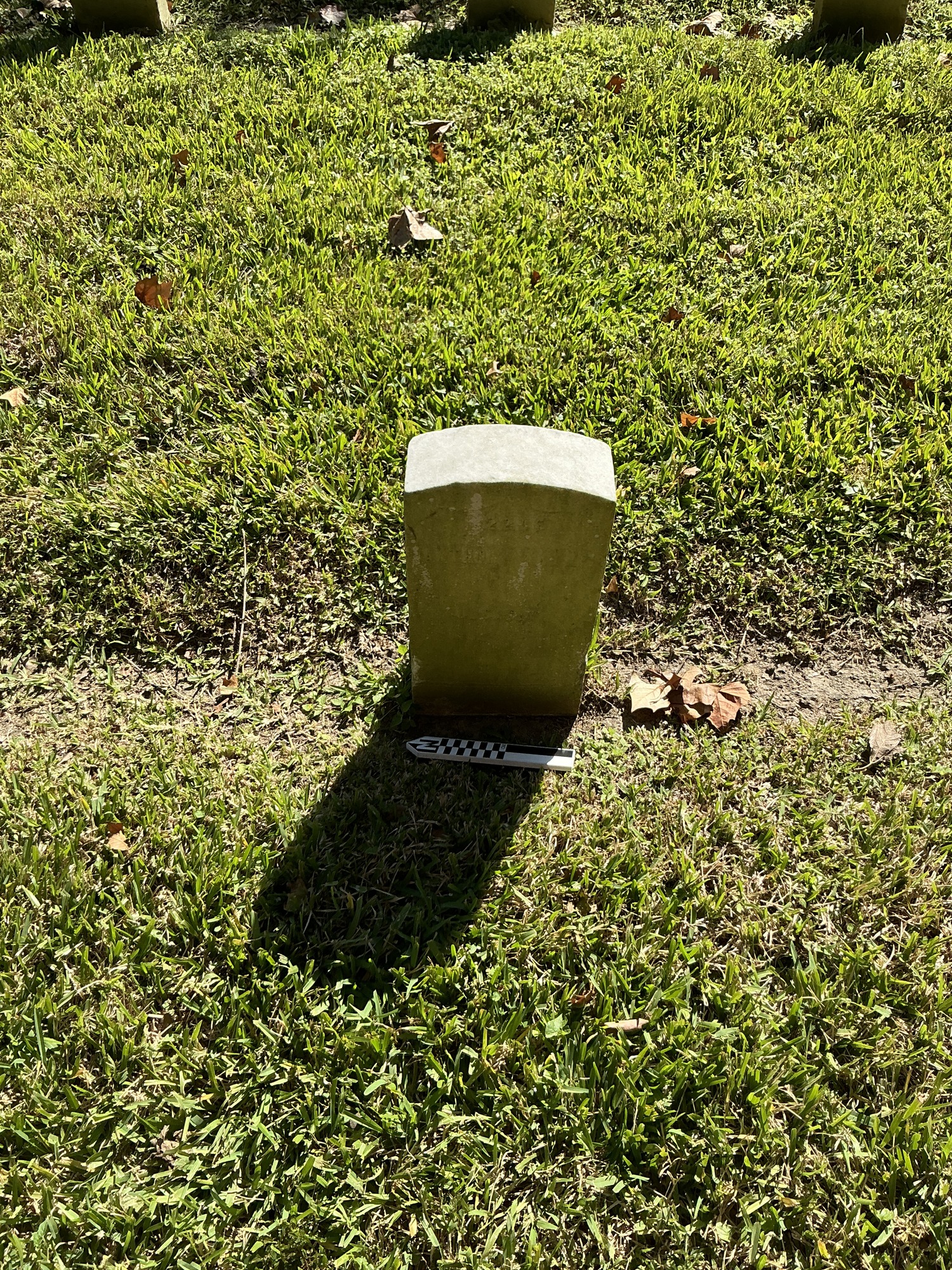 Extra image of historic upright marble headstone with recessed shield face.