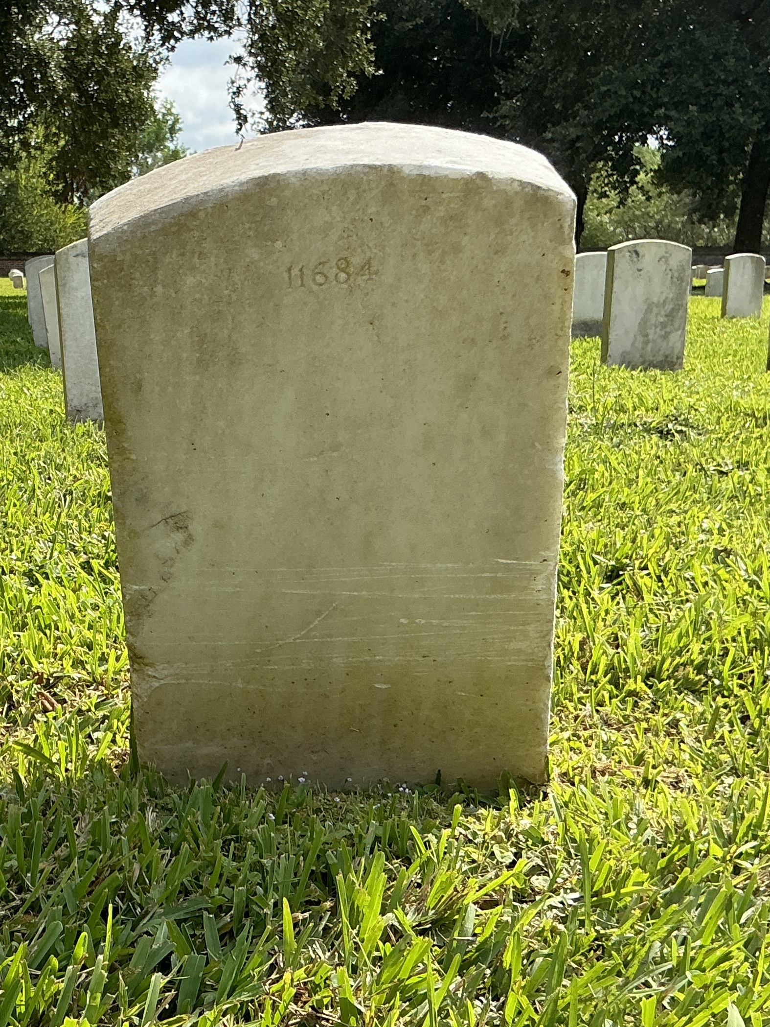 Back of upright marble headstone with flat face.