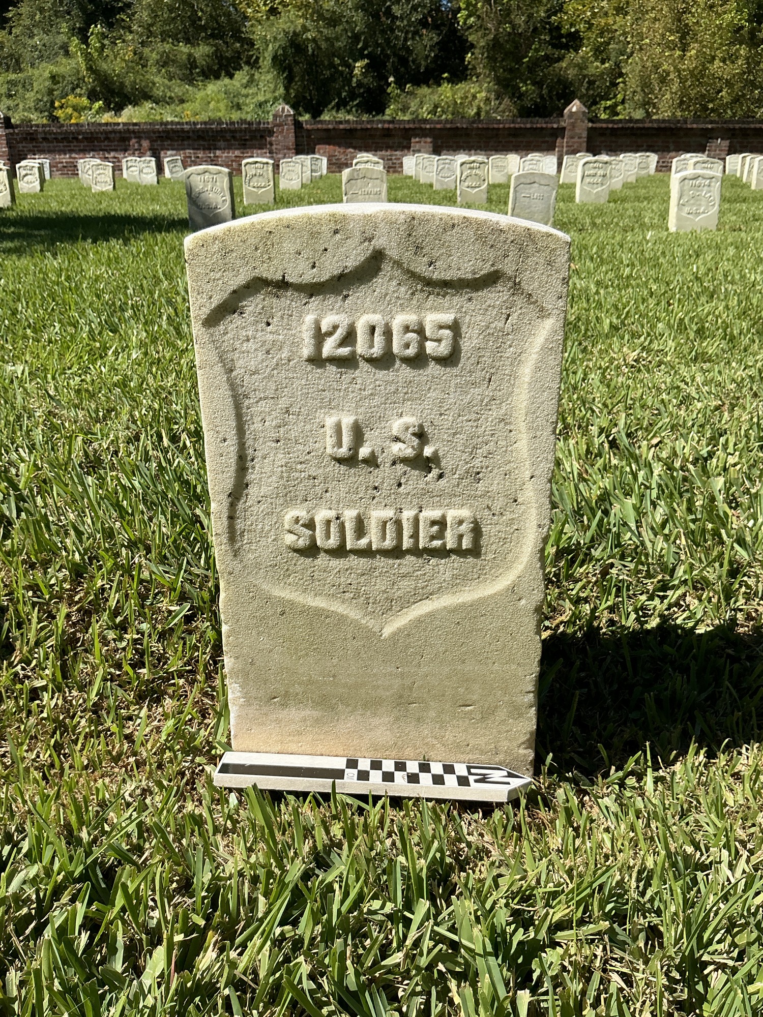 Extra image of historic upright marble headstone with recessed shield face.