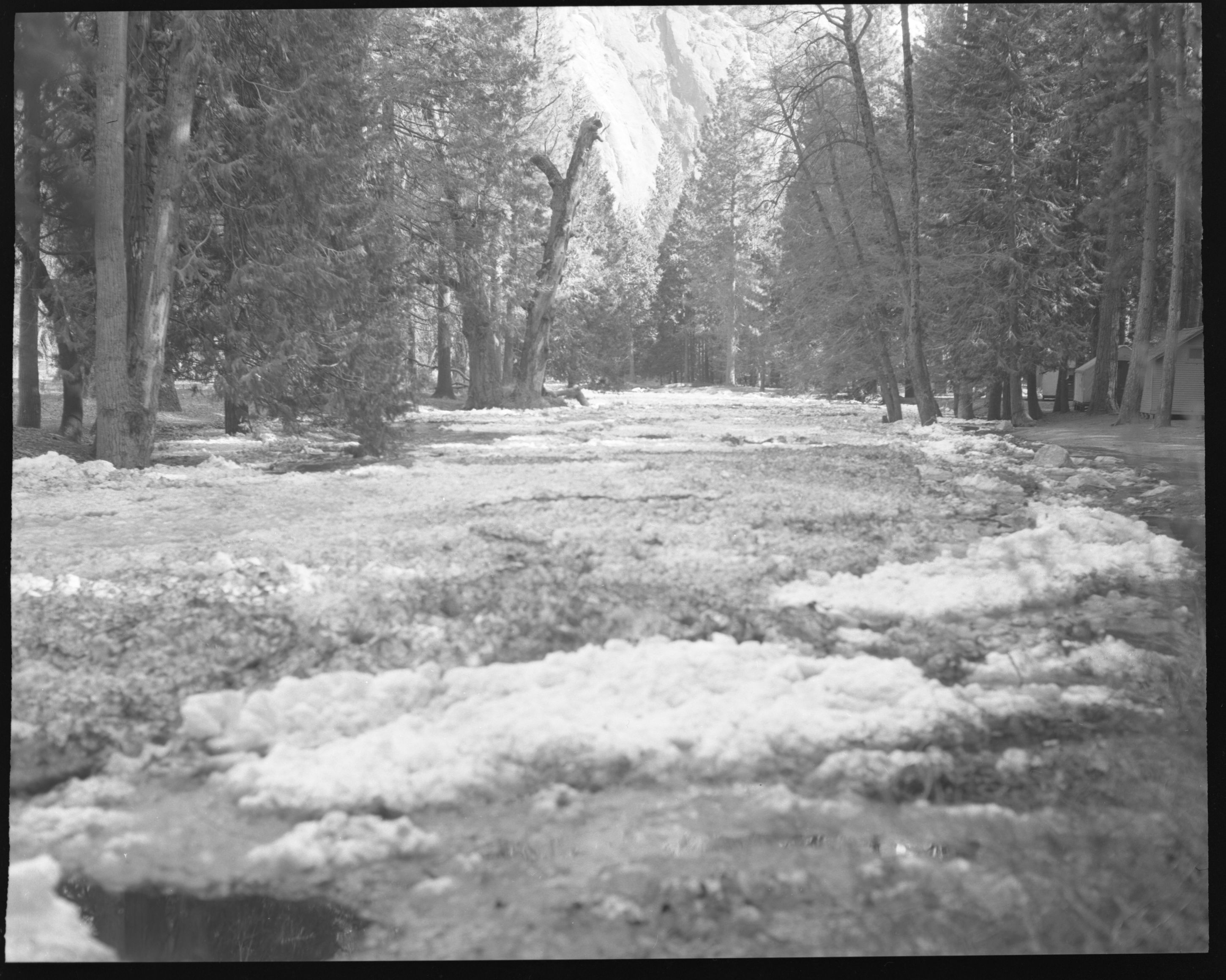 Frazil ice flowing down roadway after being diverted out of Yosemite Creek, Yosemite Valley.