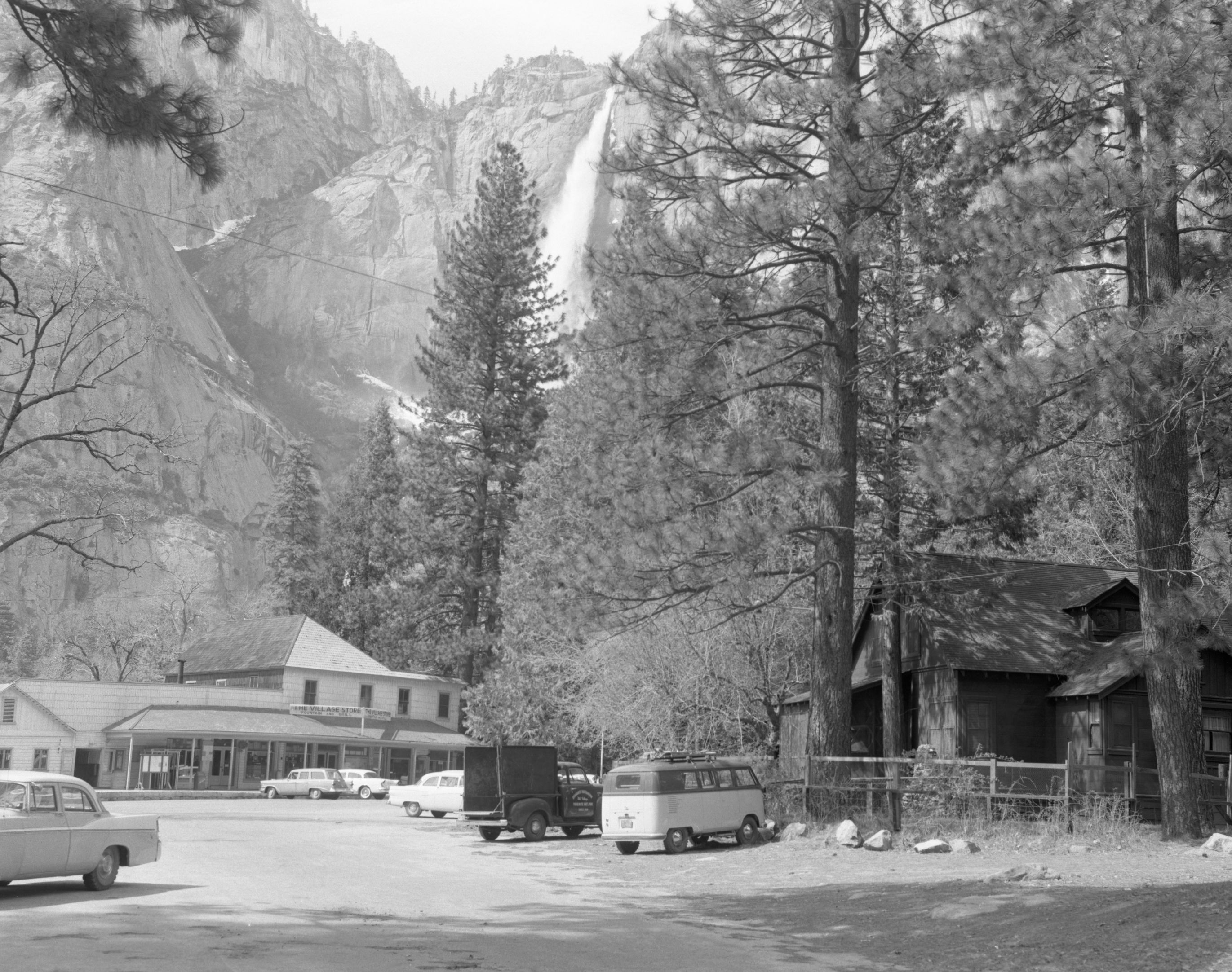 Store in Old Village and Degnan house on right. "View of structures to be eradicated under Mission 66 in Yosemite." Before image.