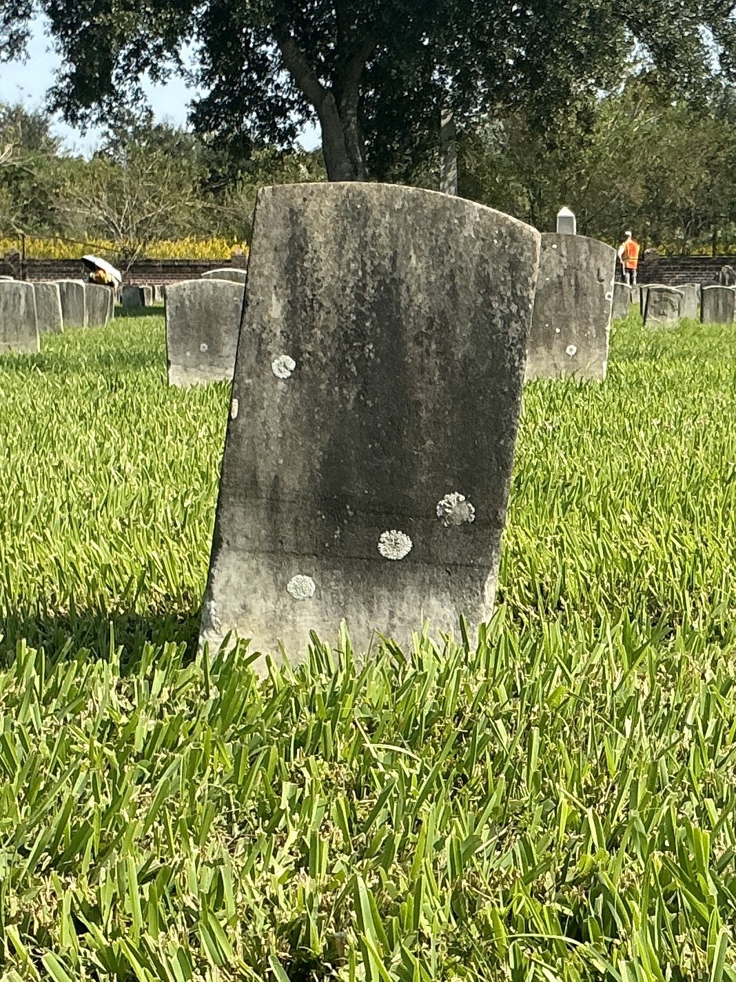 Back of historic upright marble headstone with recessed shield face.