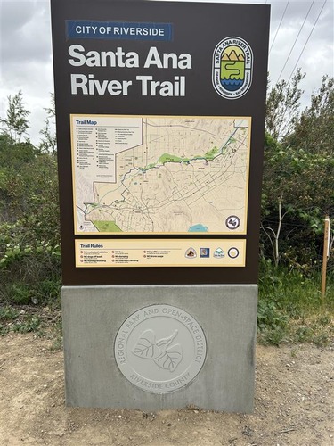 Board showing map, logos, and location name "City of Riverside Santa Ana River Trail