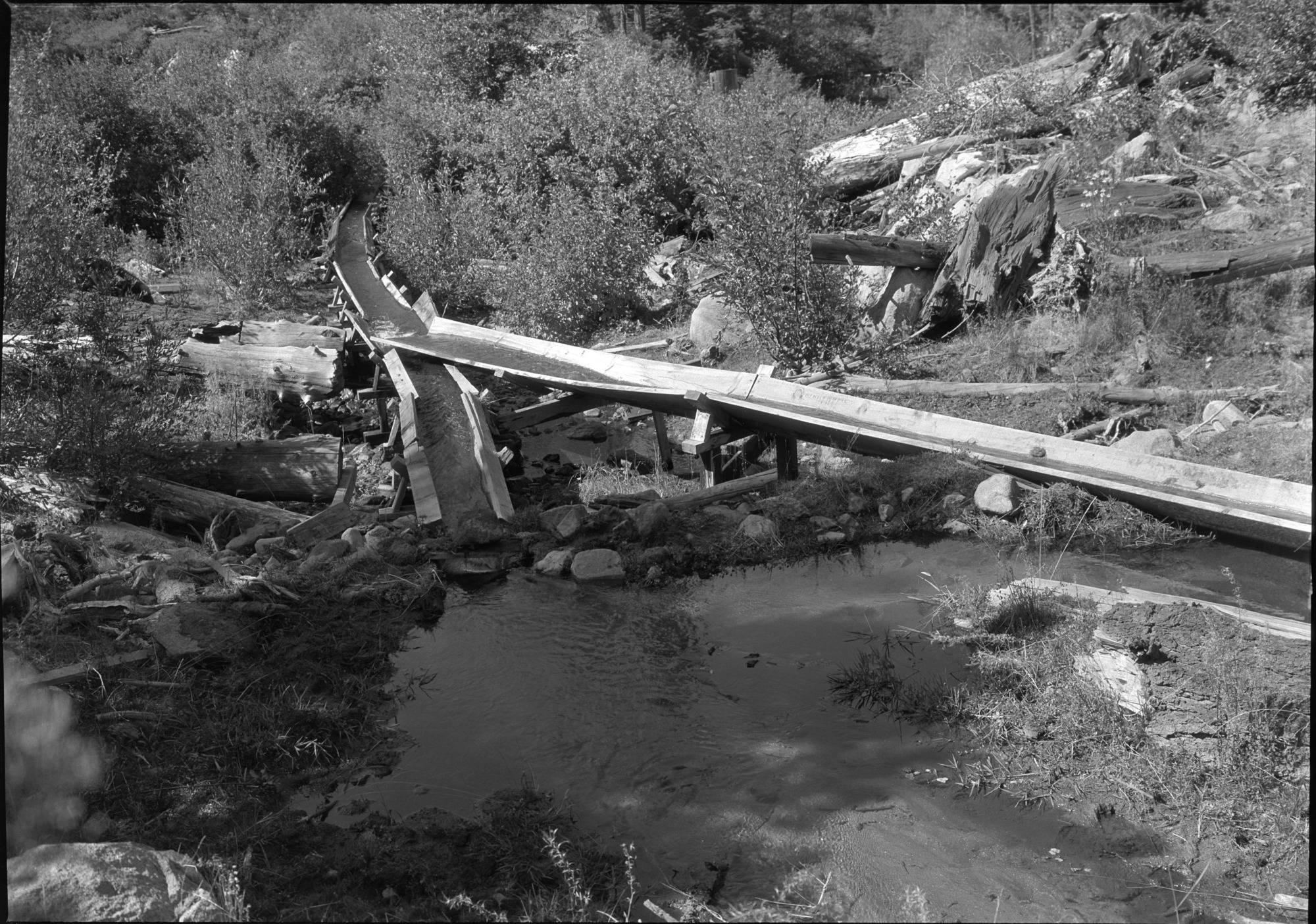 Sugar Pine Flume showing intake & dirt dam. Note leaky old flume.