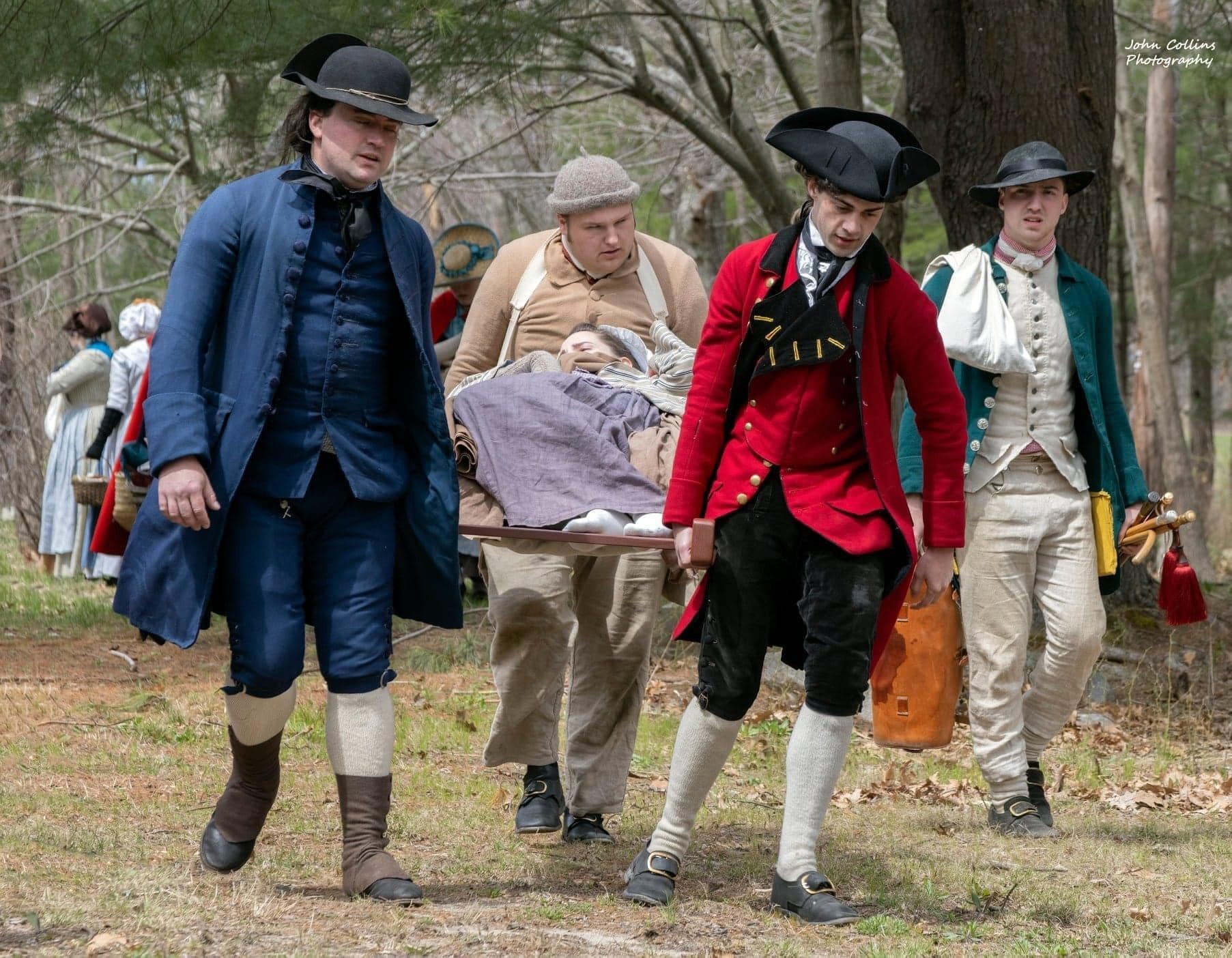 Colonial families evacuating the area with injured family member