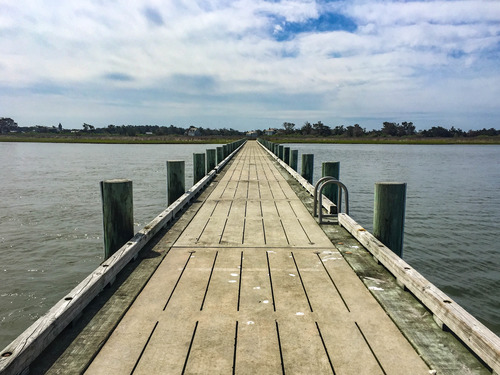 Long wooden dock leading to an island