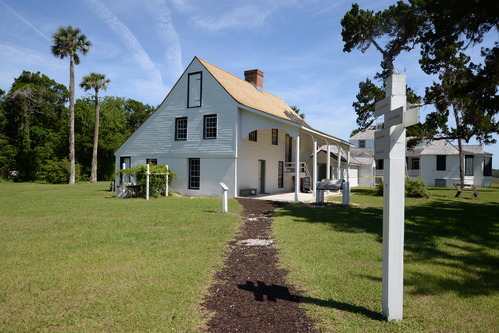 White sided white structure with centralized chimney.
