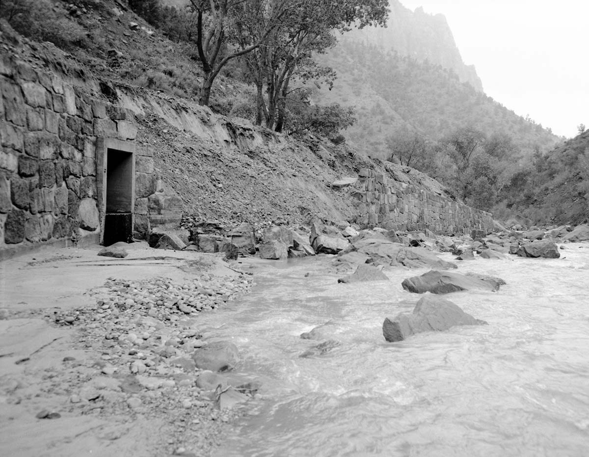 Flood damage to rock wall on Virgin River, a quarter mile south of Court of Patriarchs. Record of damage or defective workmanship.