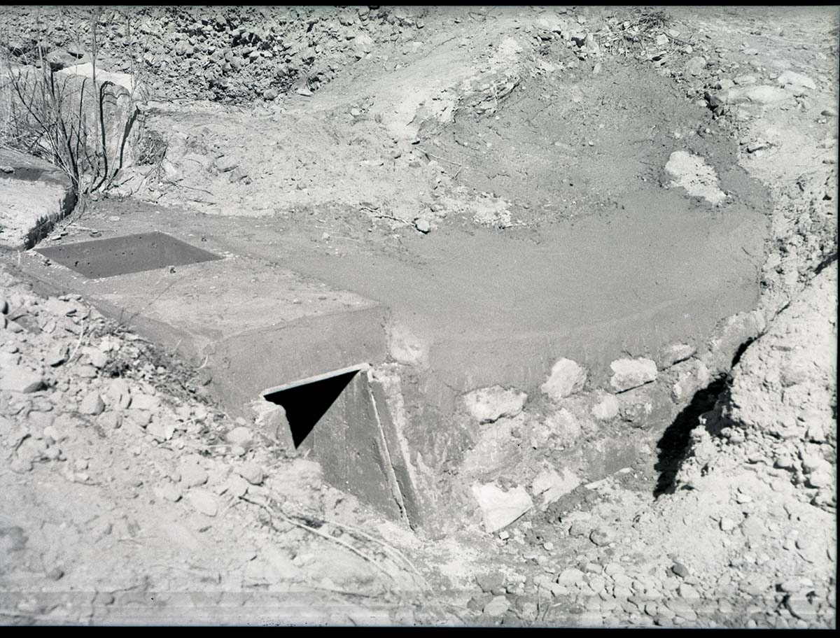 Irrigation ditch, west bank of Virgin River, 200 yards north of bridge. Concrete protection of water flume, and man-hole for clean out.