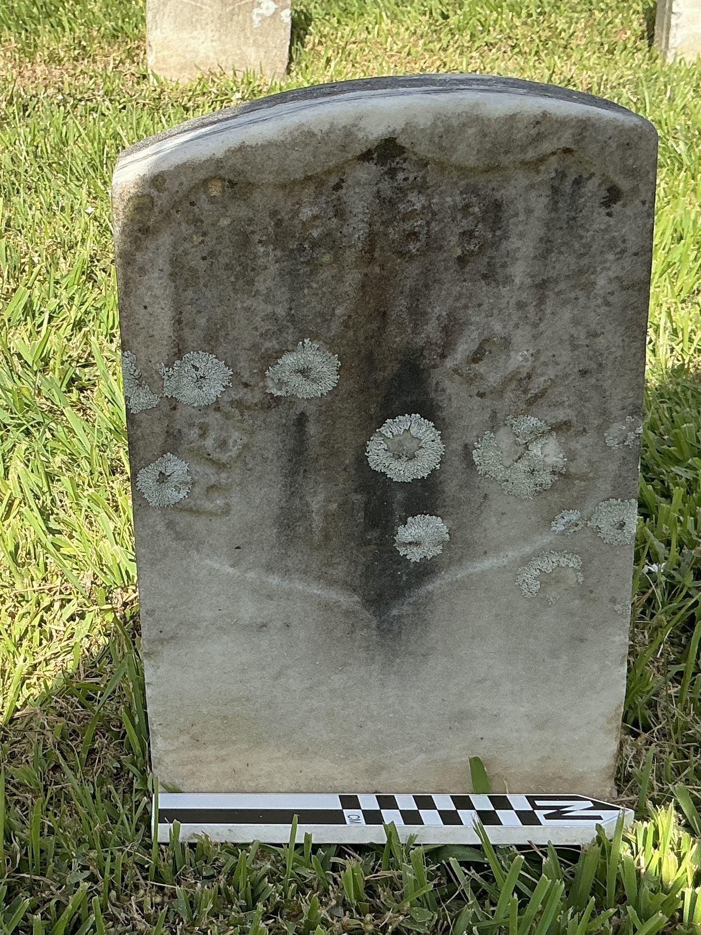 Extra image of historic upright marble headstone with recessed shield face.