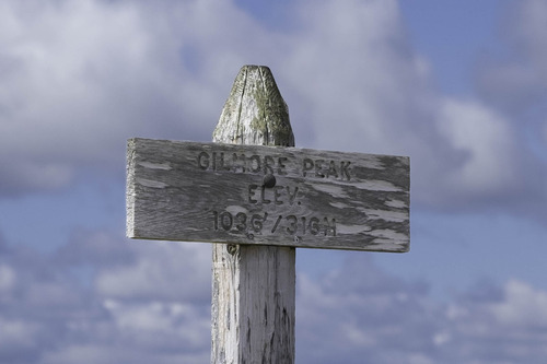 The elevation sign at the top of Gilmore Peak (1036 ft/316m).