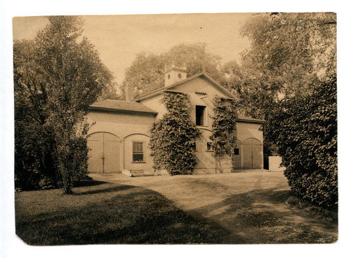 Black and white photograph of carriage house.