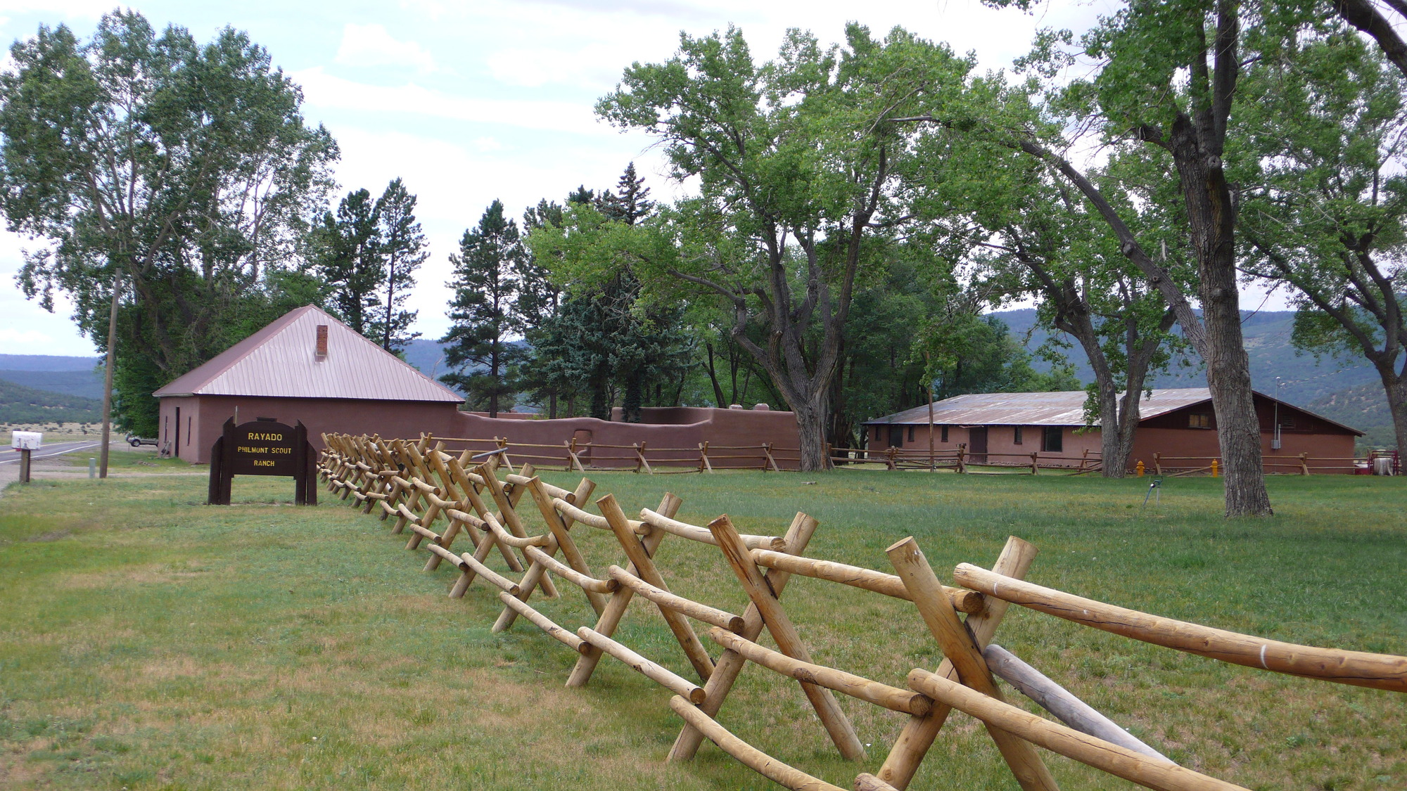 A wooden fence in a grassy area.