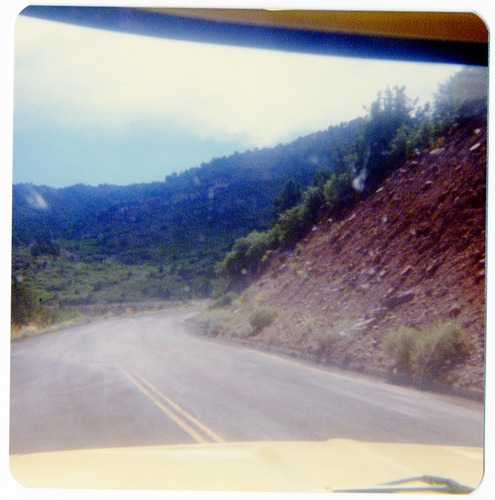 View through car windshield of the Kolob Terrace Road - North Unit and surrounding landscape.