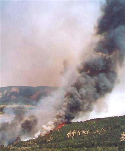 Intense burning with heavy gray and black smoke and flames during the Bircher fire, Mesa Verde National Park, July 2000