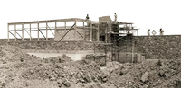 A black and white photo off a foundation at a construction site. 
