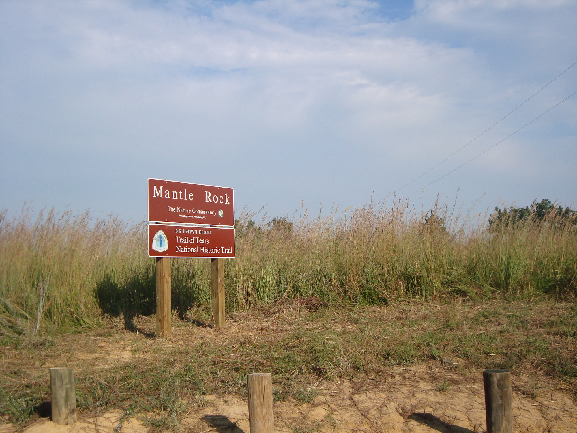 A sign in the middle of a field.