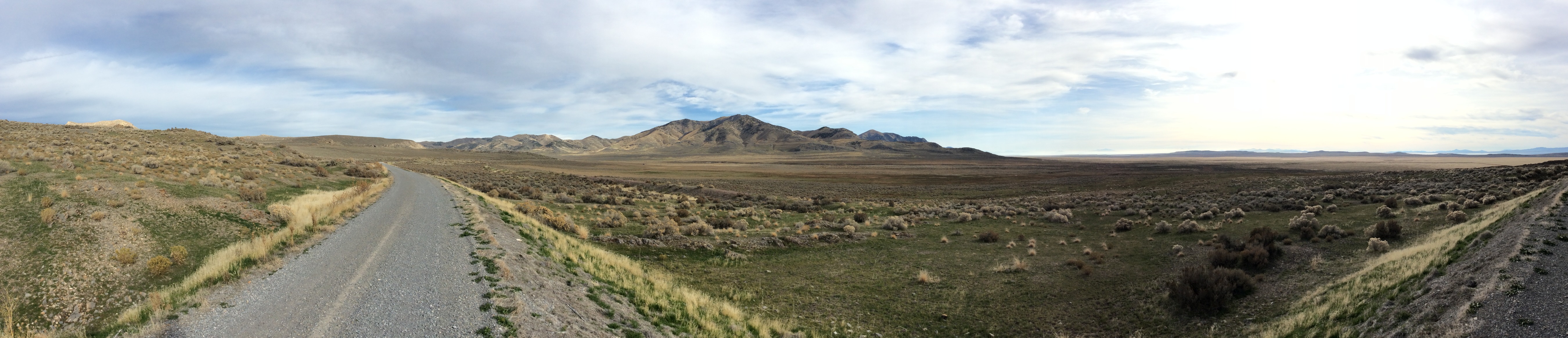 Two grades snake through a sagebrush filled valley. 