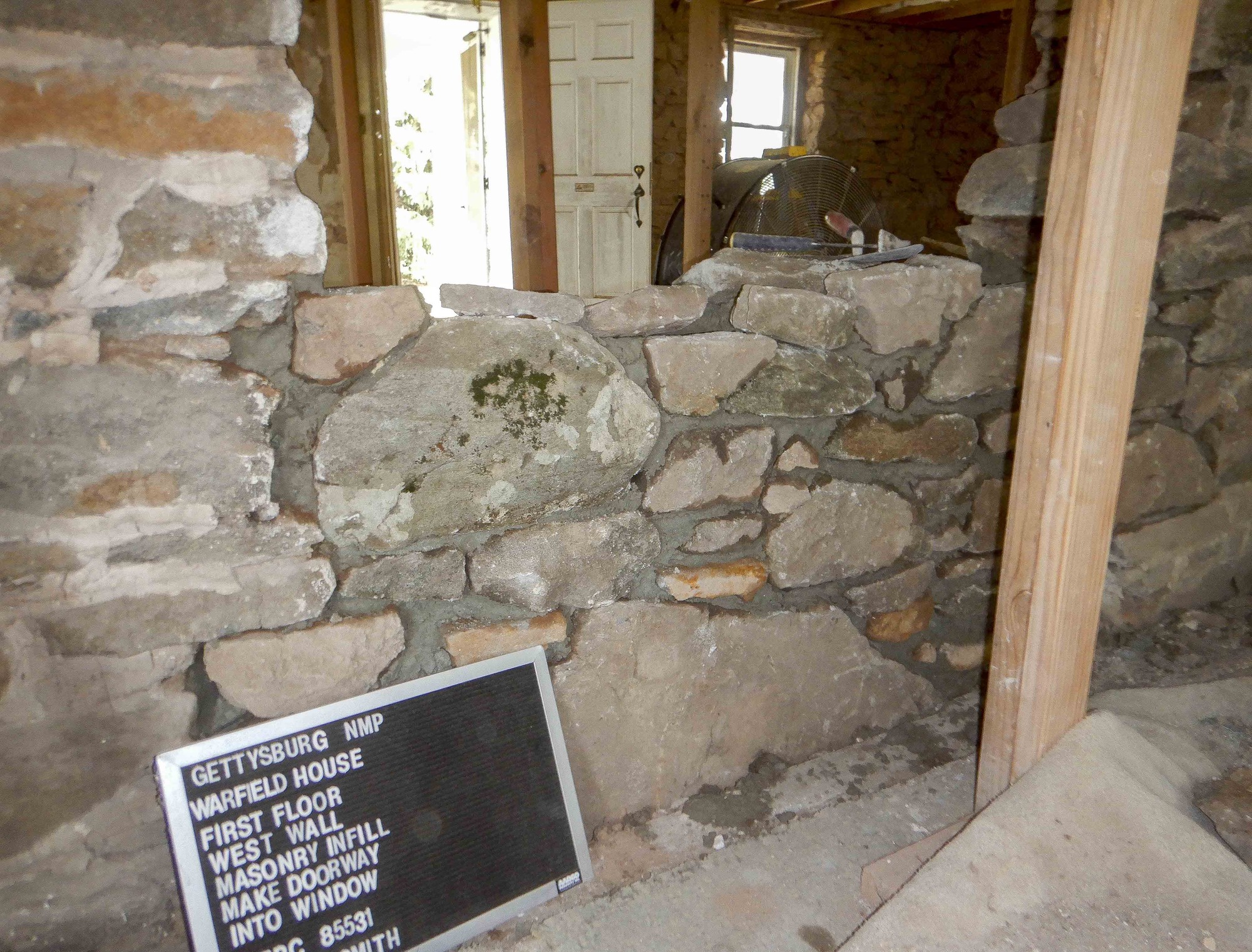 Masonry work continues as the doorway opening is beginning to look like a window opening.