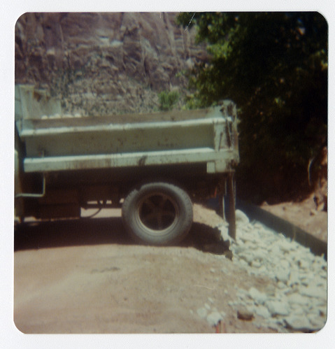 Truck dropping gravel onto side of road along the Zion-Mt. Carmel Highway switchbacks.
