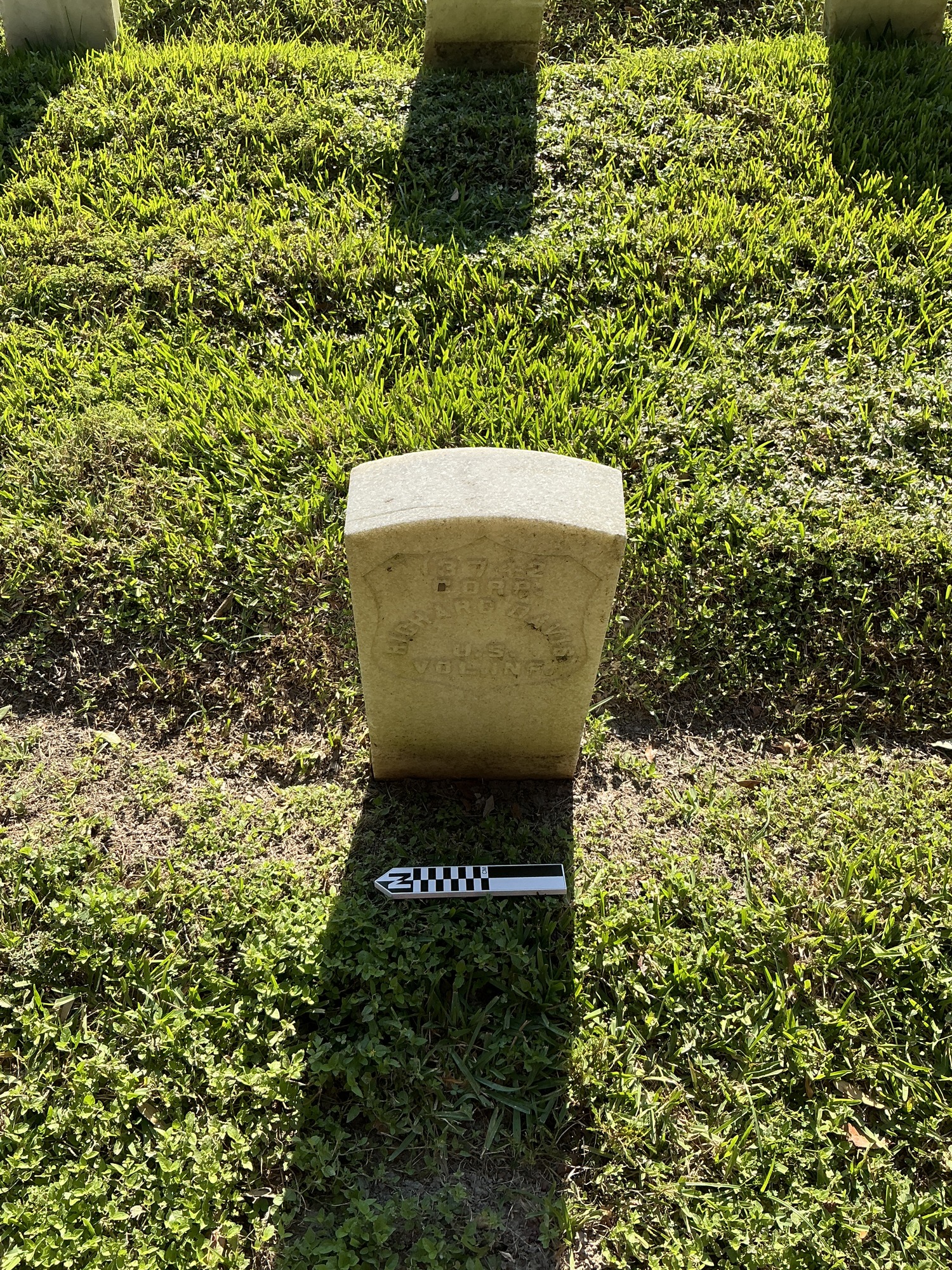 Extra image of historic upright marble headstone with recessed shield face.