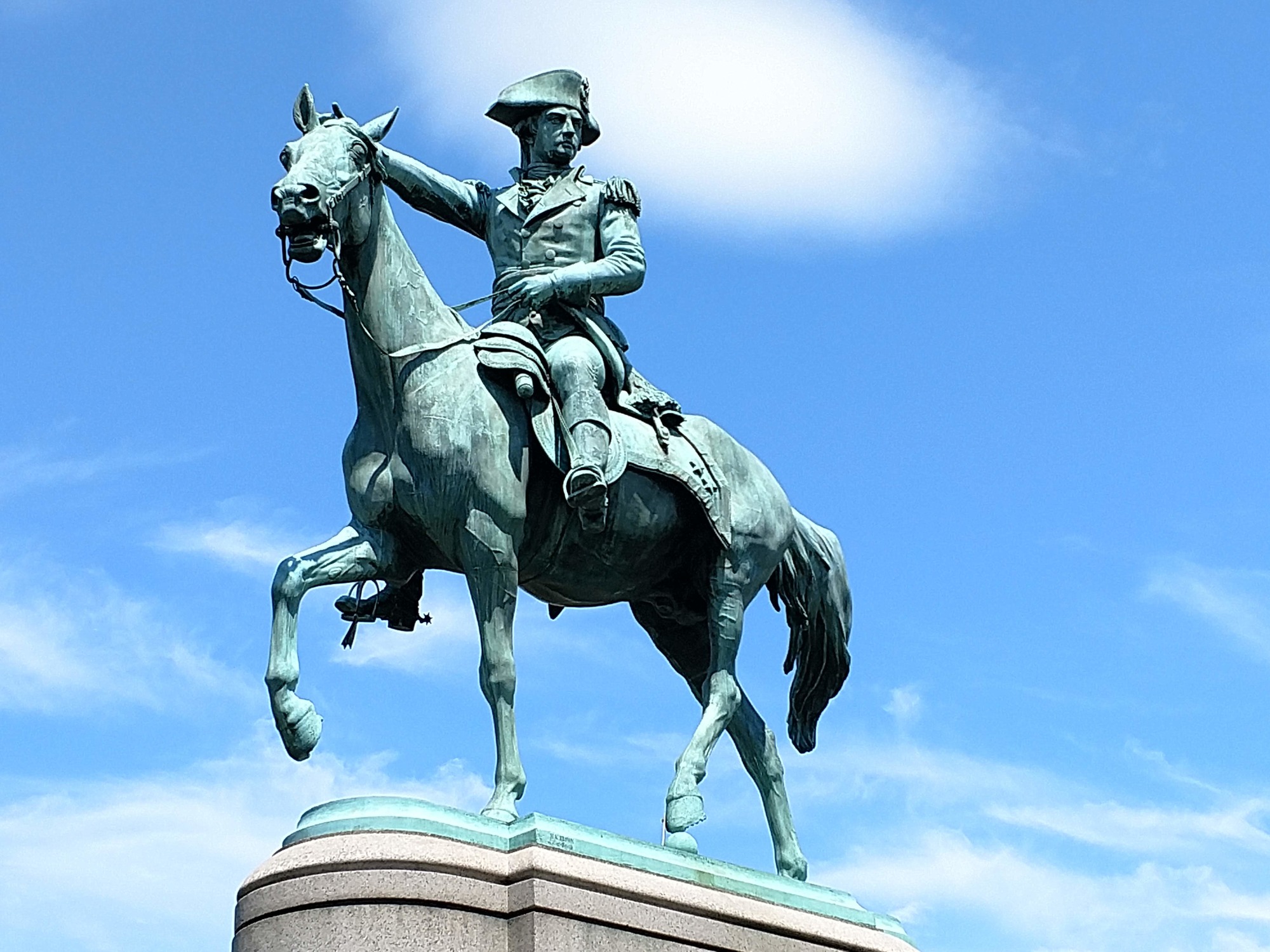 A statue of Nathanael Greene riding a horse. He is pointing his out in the distance