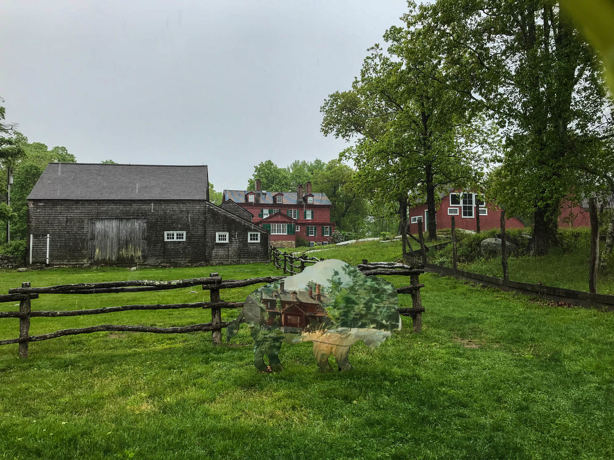 Bison cutout colored as a Weir painting with historic buildings in the background 