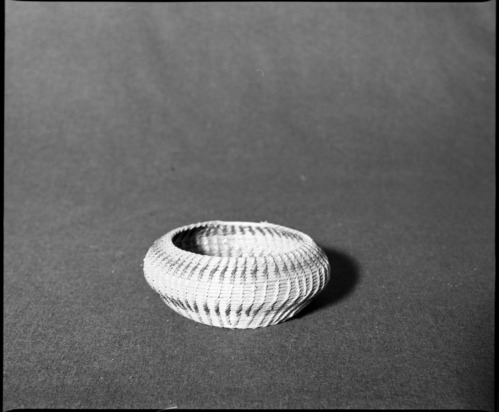 Marie Rozier Collection, Catalog No. 48. Object: Washoe basket. Dimensions: 6 1/2 x 2 1/2". Materials: Willow, fern root. Technology: Leftward coil direction, non-interlocking stitching, oval start made by wrapping bent willow cull. Collection History: Purchased at Virginia City by Mary Long. Photographed by Michael Dixon, December 1982. Catalogued by Craig Bates and Barbara Beroza. Yosemite Collections, National Park Service.