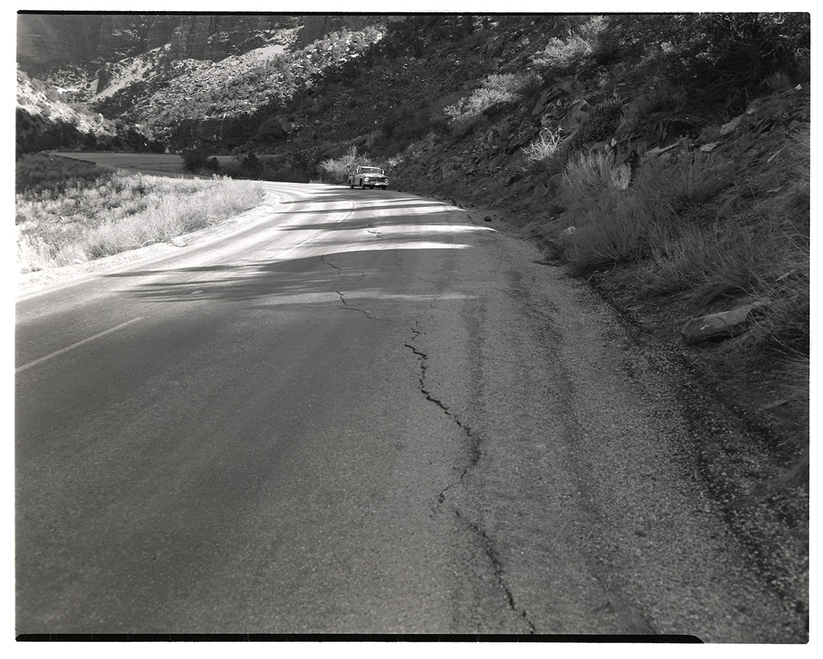 Crack in road in need of repair along the Zion-Mt. Carmel Highway switchbacks.