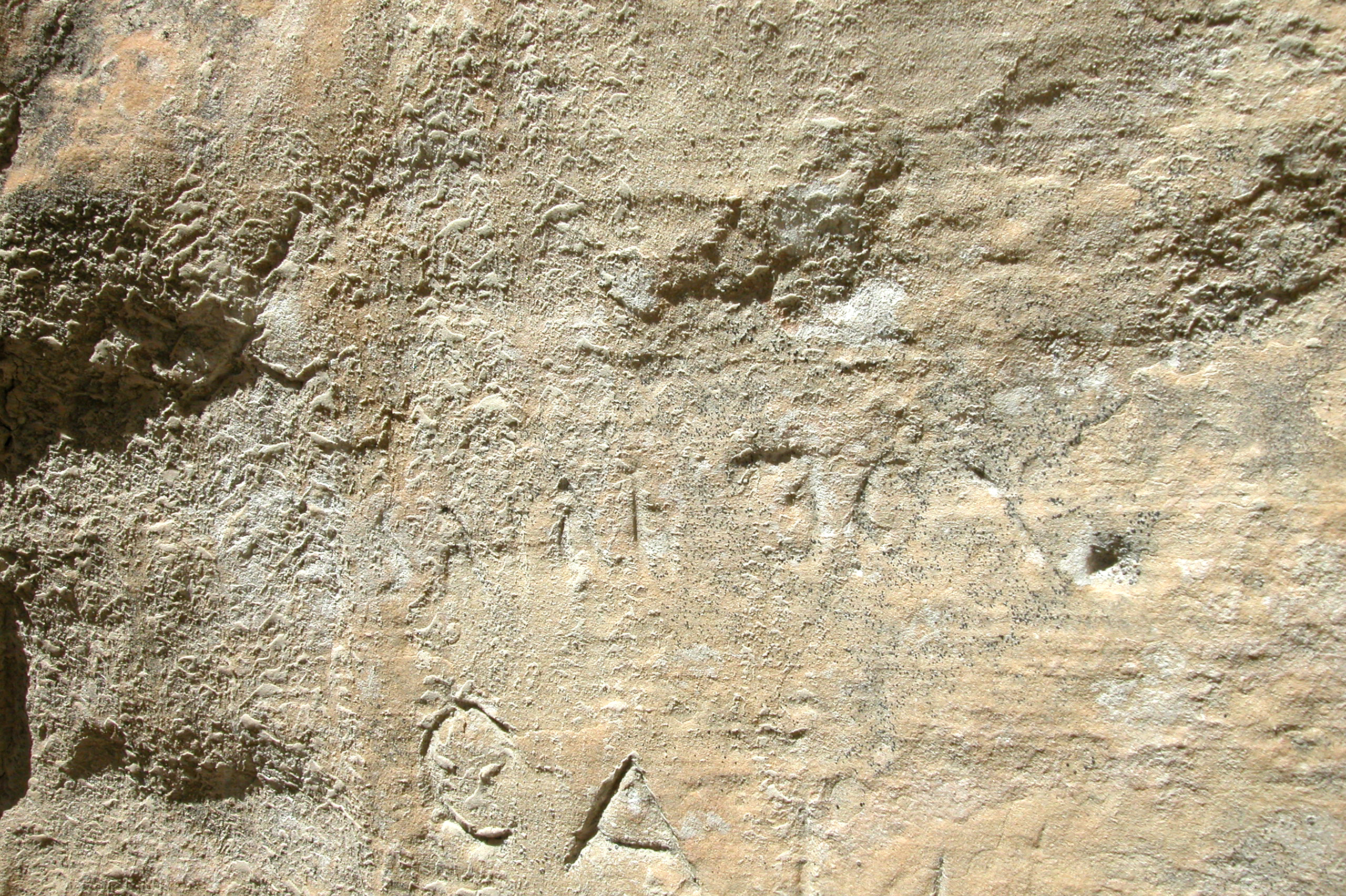 Sarah Fox is barely legible, etched in the brown sandstone of El Morro.  Weathered sand sticks to the rock.