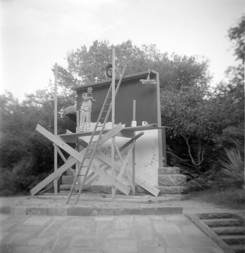 Man working on the South Campground Amphitheater screen and projector.