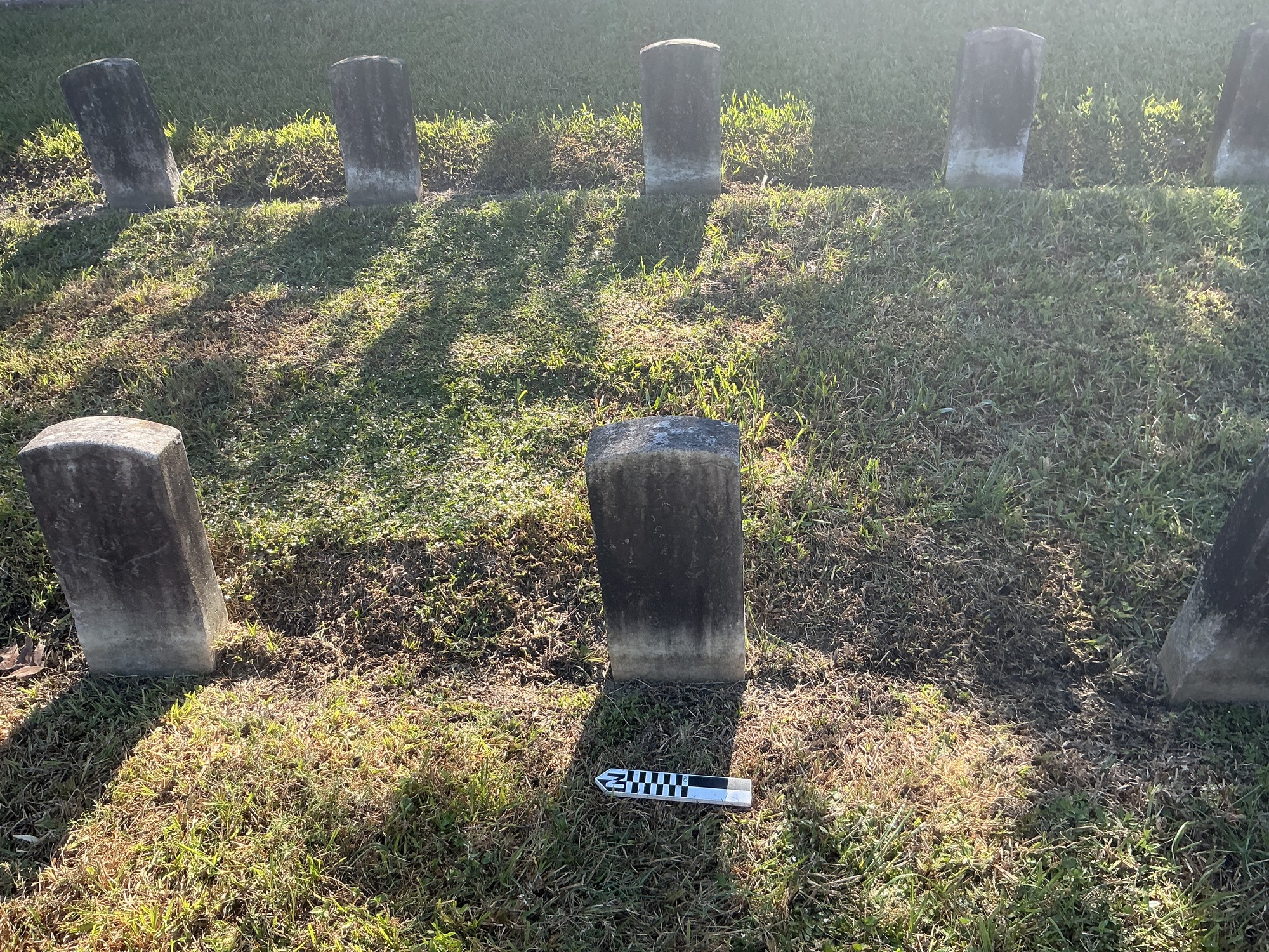 Extra image of historic upright marble headstone with incised shield face.