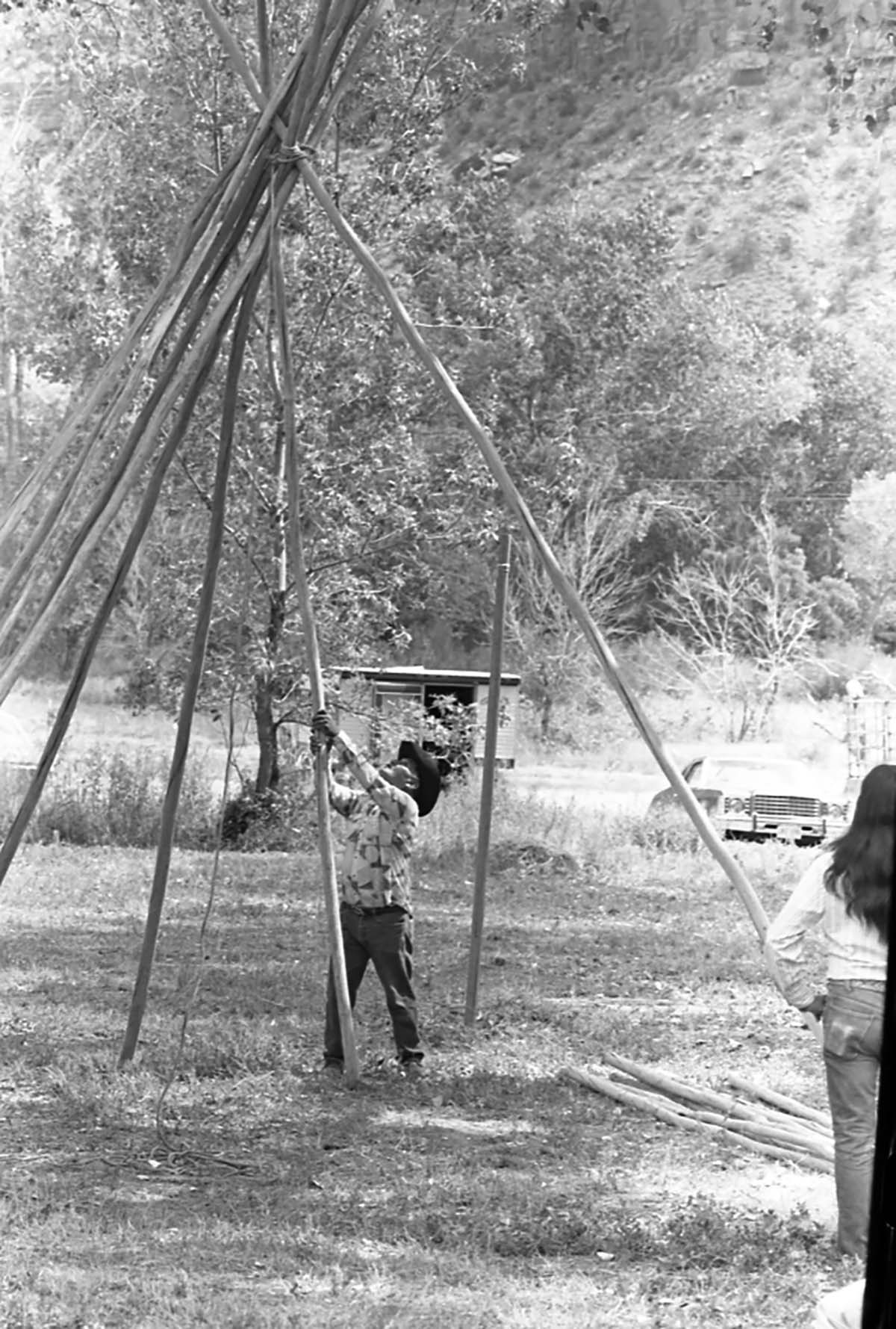 Clifford Jake setting up poles for his tipi demonstration at the second annual Folklife Festival, Zion National Park Nature Center, September 7-8, 1978.