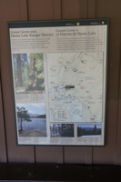 A metal panel with a map on it sits on a brown wooden wall
