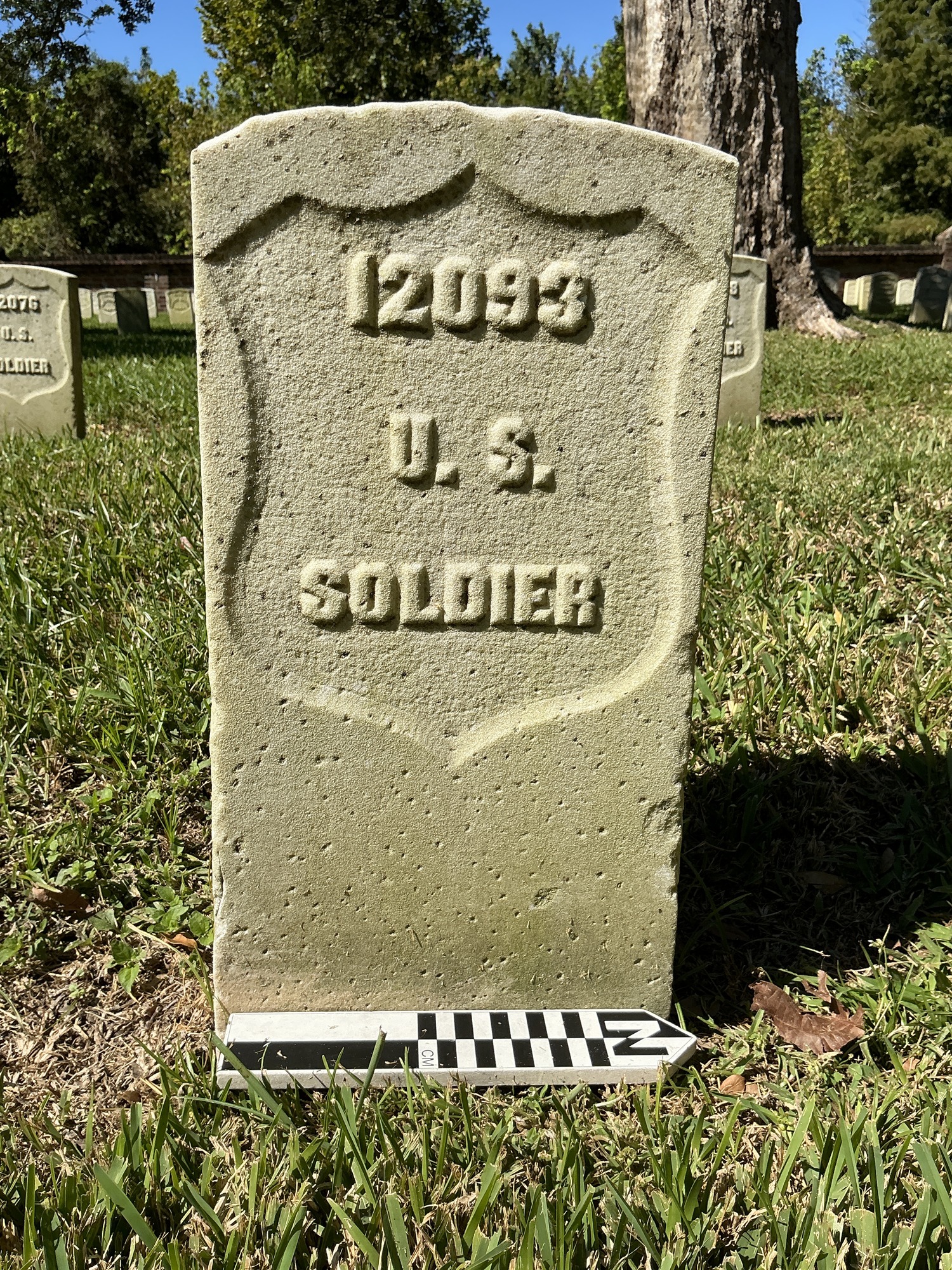 Extra image of historic upright marble headstone with recessed shield face.