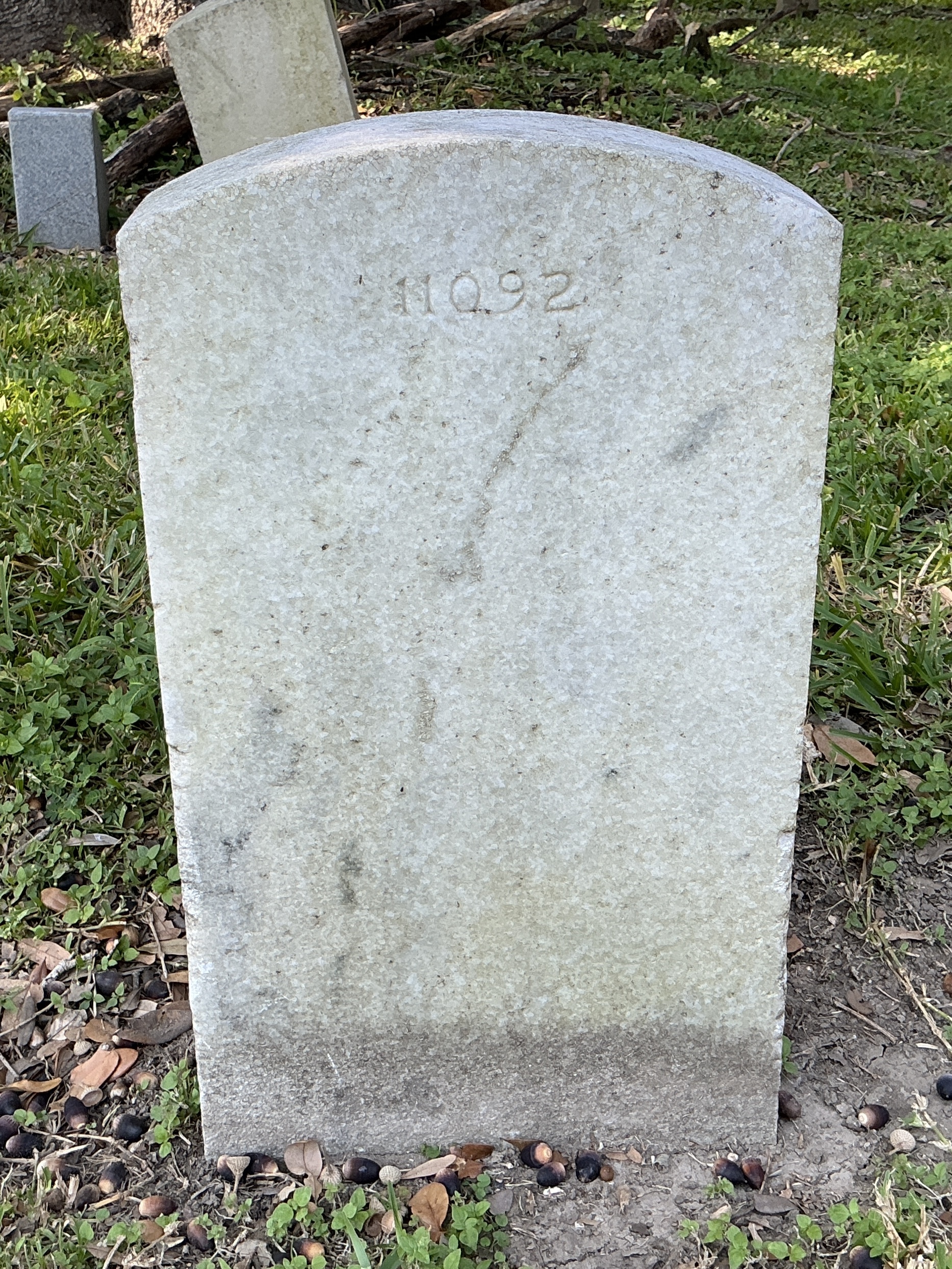 Back of upright marble headstone with flat face.