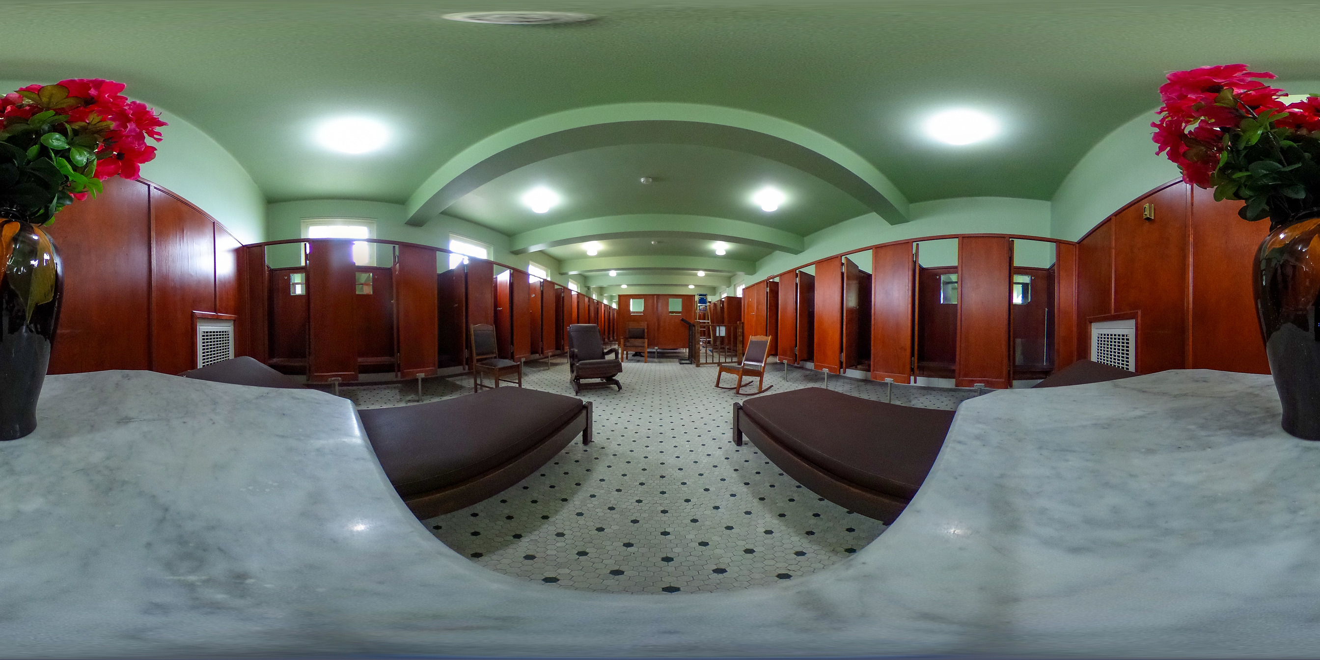 A room with many wooden stalls for changing before and after bathing