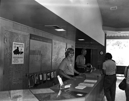 Student Conservation Association (SCA) volunteers, Mark McKibben and Ken Kertell (NPS) at Visitor Center information desk.