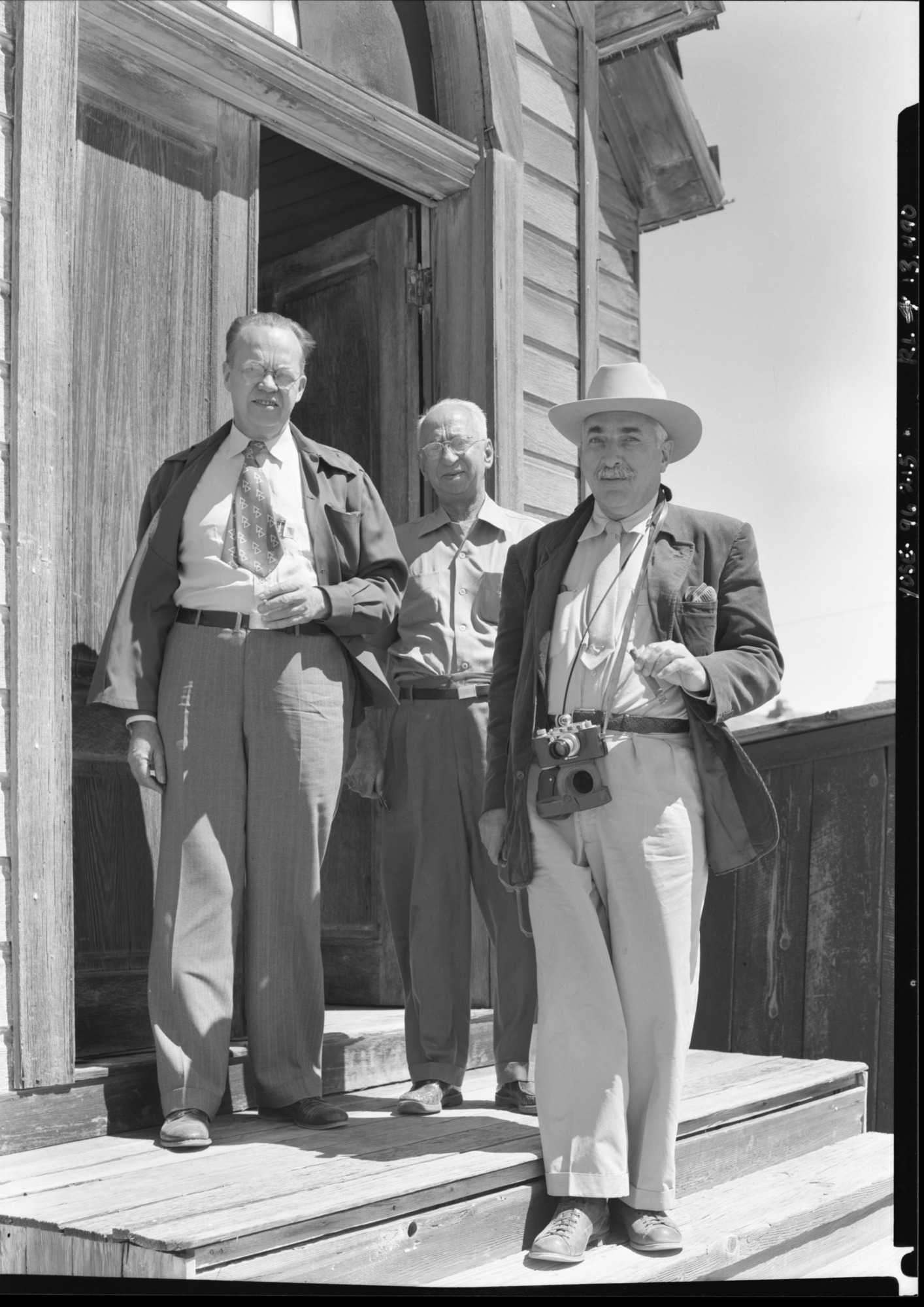 At doorway of old church at Bodie, CA. L to R: Carl Russell, Floyd Nourse and Alfred Knopf. Note: Floyd Nourse, 526 Viriginia Ave. San Mateo, CA. Alfred A Knopf, Inc. 501 Madison Ave, N.Y.C.