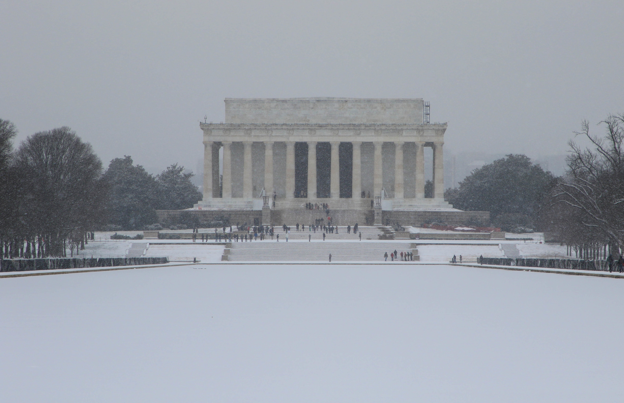 Lincoln Memorial on the far side of the snow-covered Reflecting Pool