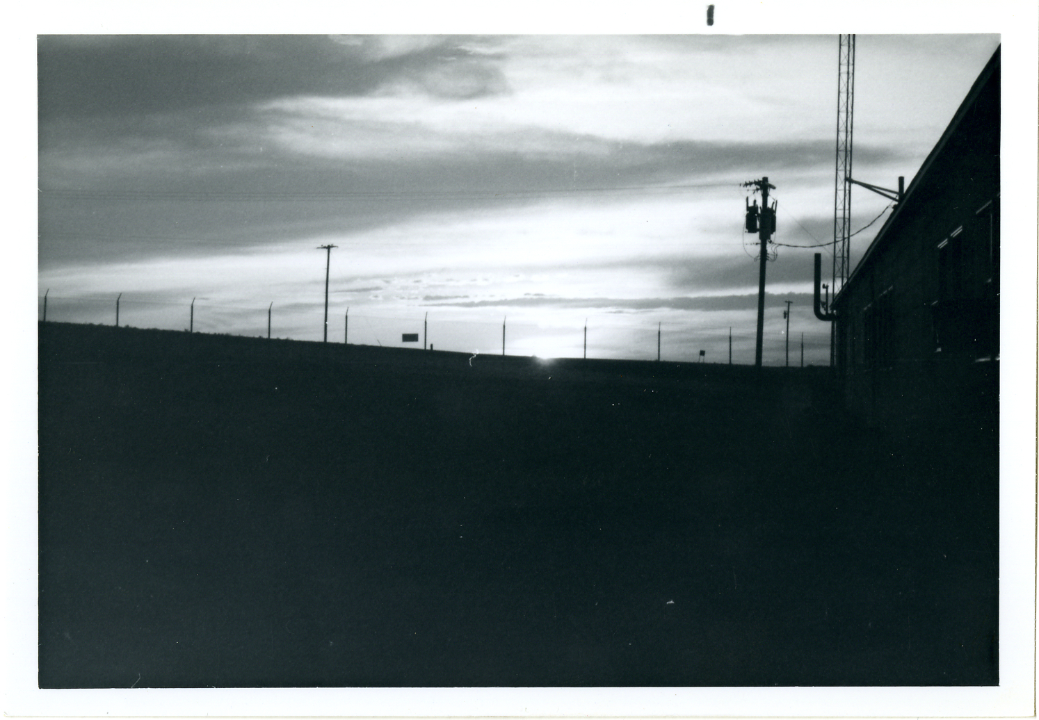Sunset seen through a fence