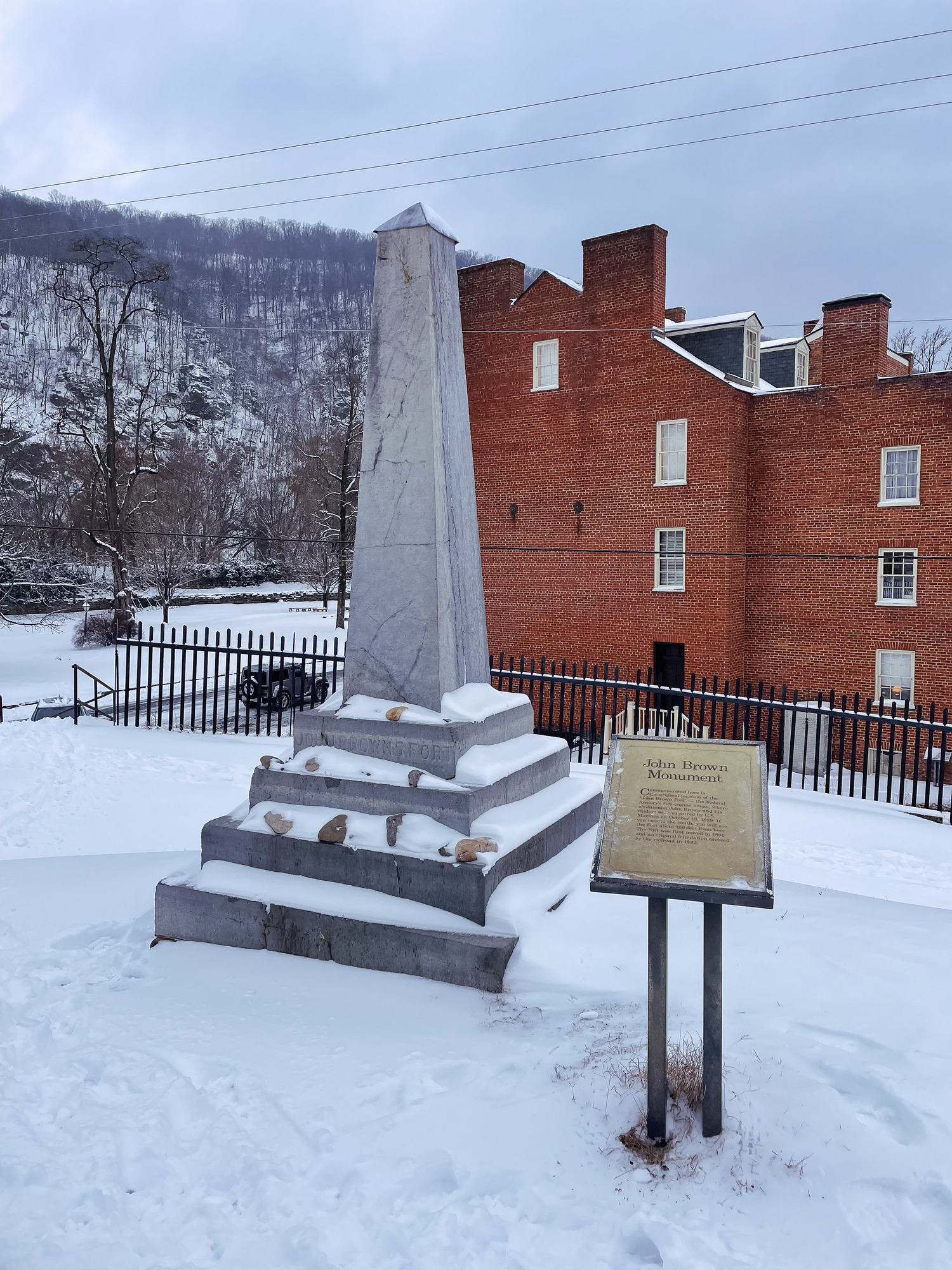 The John Brown Monument at Harpers Ferry National Historical Park surrounded by snow.