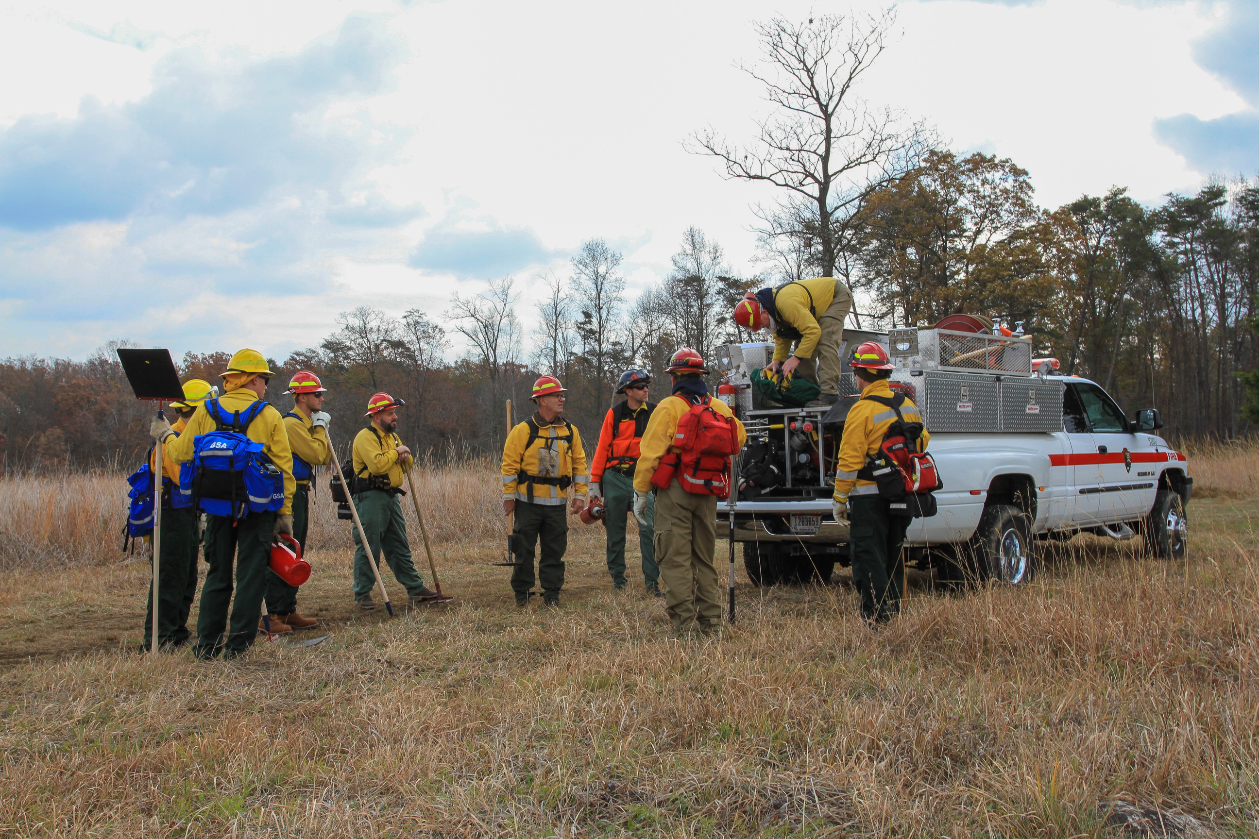 Wildland firefighters use drip torches and tools manage prescribed fire near Brawner Farm at Manassas National Battlefield Park. 
